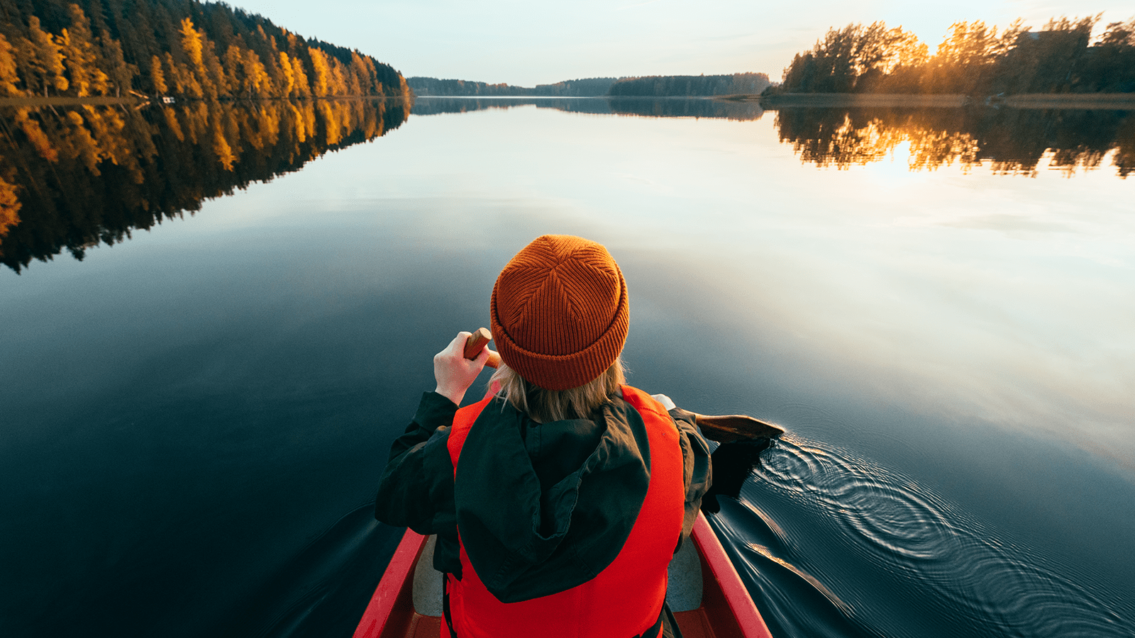 Person paddling on a lake.