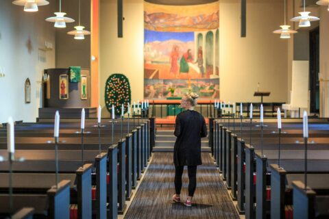 Person walks down the aisle of Muurame church