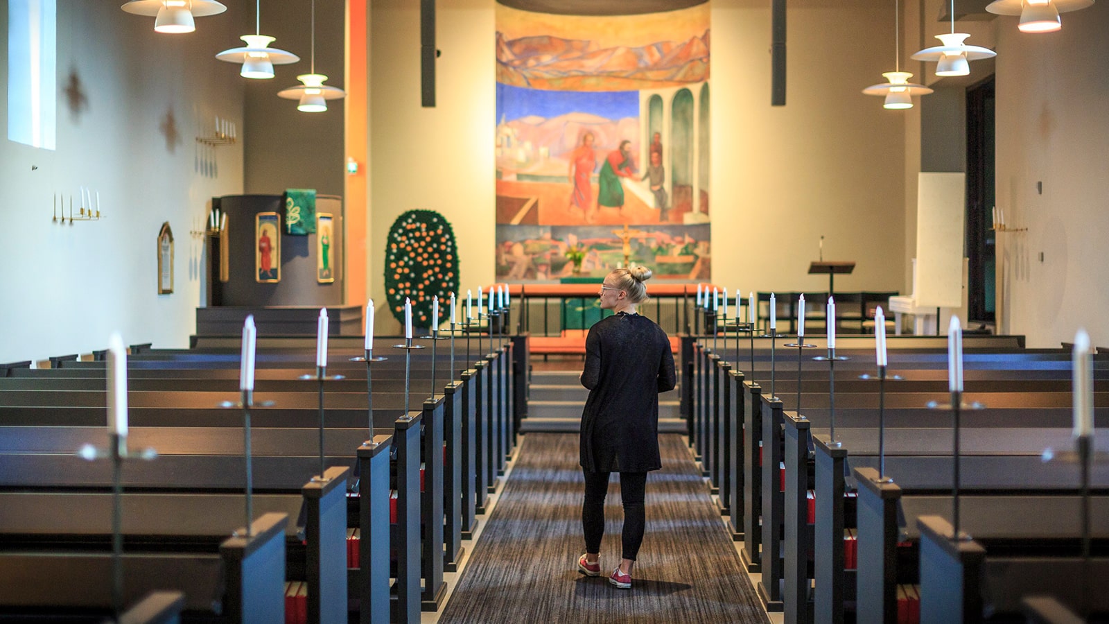 Person walks down the aisle of Muurame church