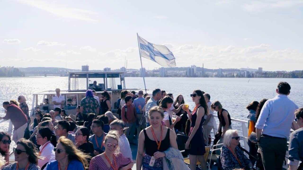 A group of people on a lake cruise on a summer's day.