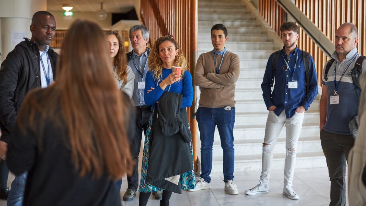 A group of people in the lobby of the main building of the University of Jyväskylä.