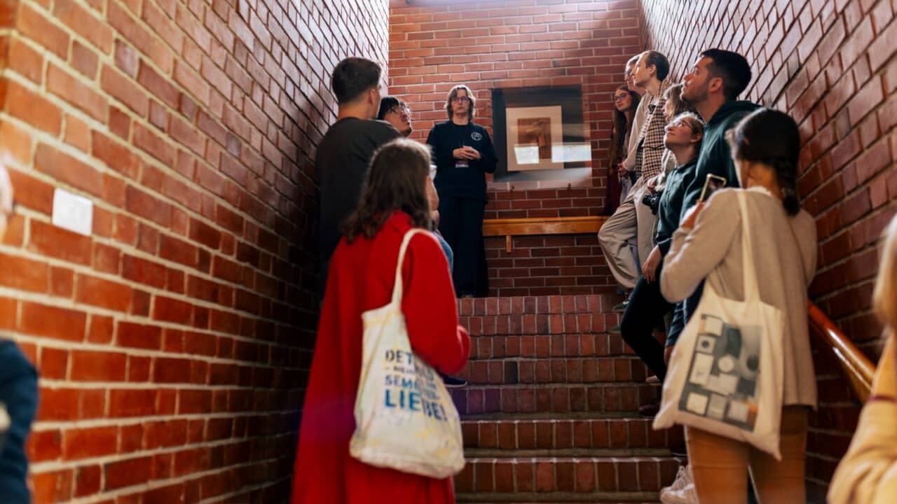 People on a guided tour of the Säynätsalo Town Hall, designed by Alvar Aalto.