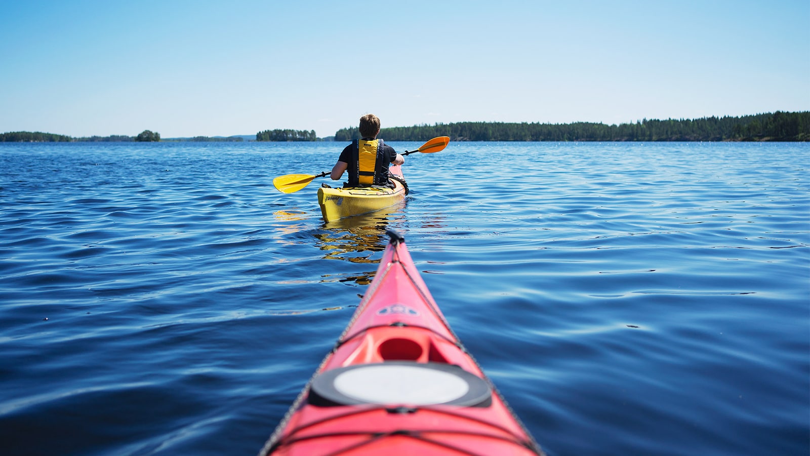 Two persons kayaking at Konnevesi
