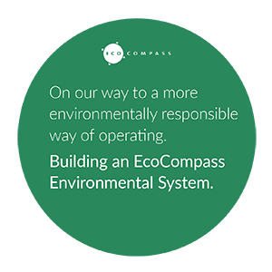 EcoCompass logo in english: On our way to a more environmentally responsible way of operating. Building an EcoCompass Environmental System.