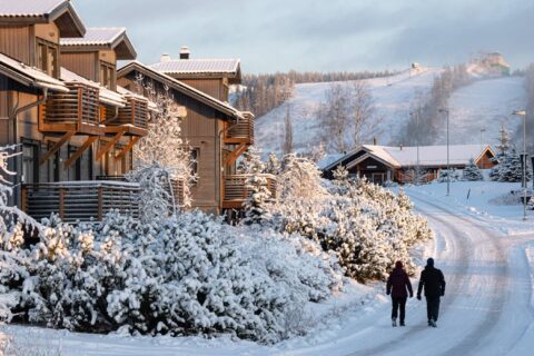Two persons walking on a street on winter