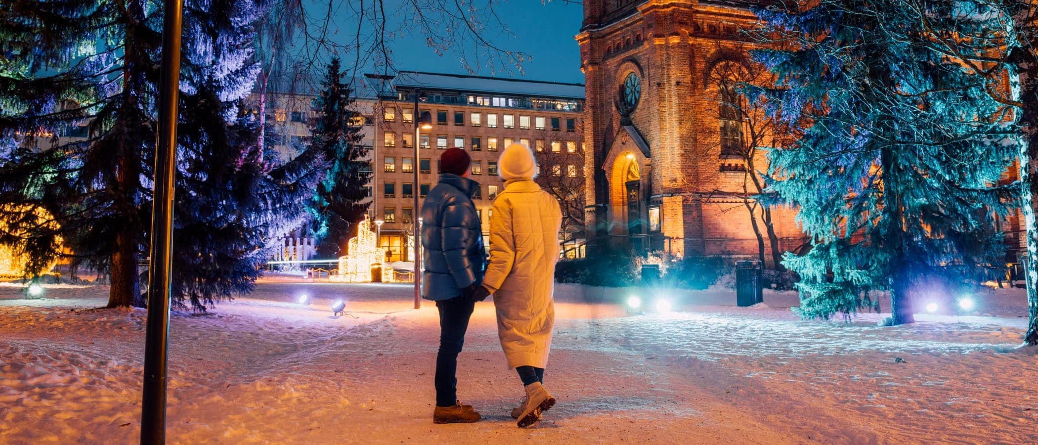 Two persons at the Jyväskylä Church Park at Christmas time.