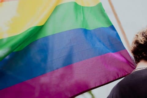 A person carrying a big Pride-flag.