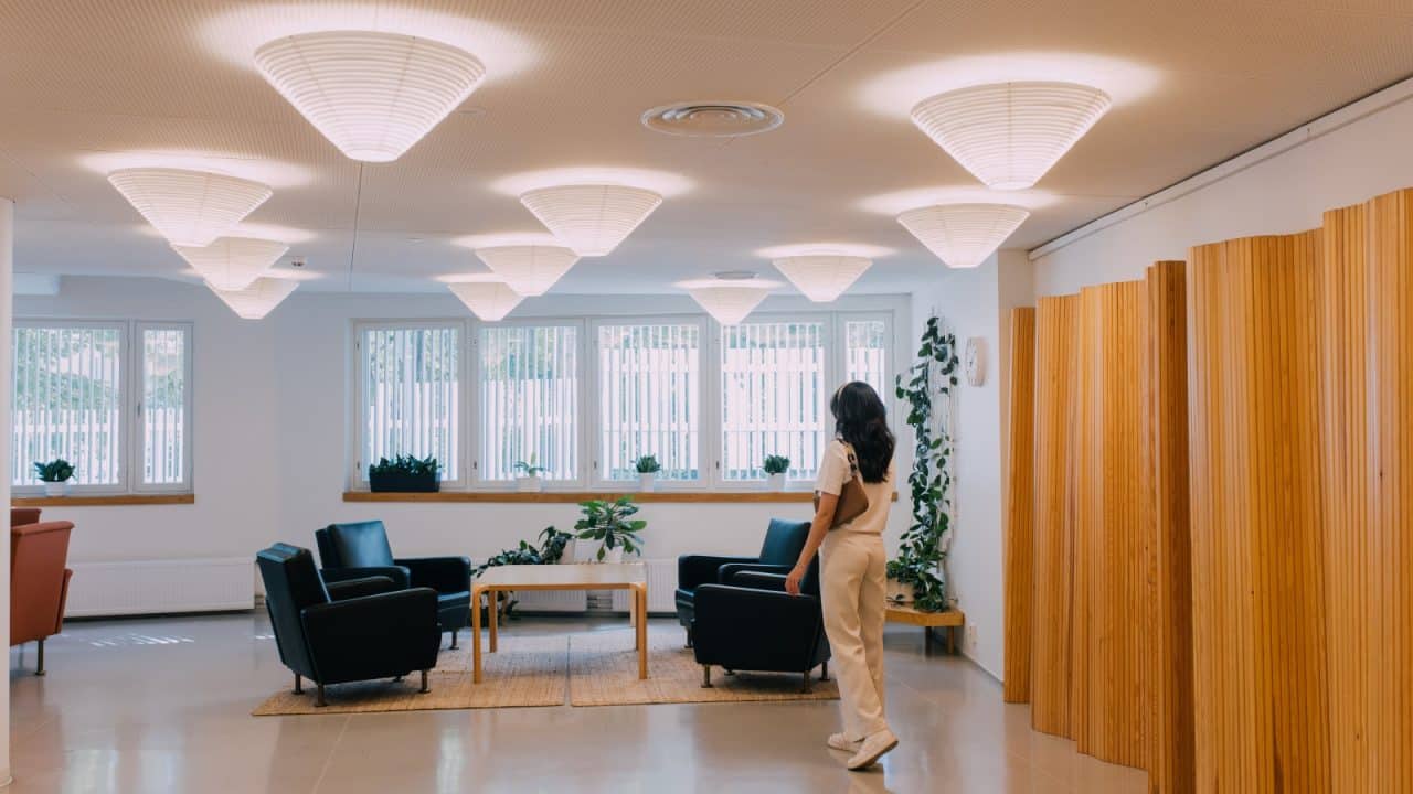 Person walking in a room in the Aalto2 Museum Centre.