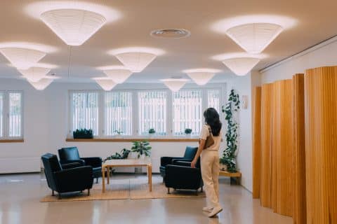 Person walking in a room in the Aalto2 Museum Centre.