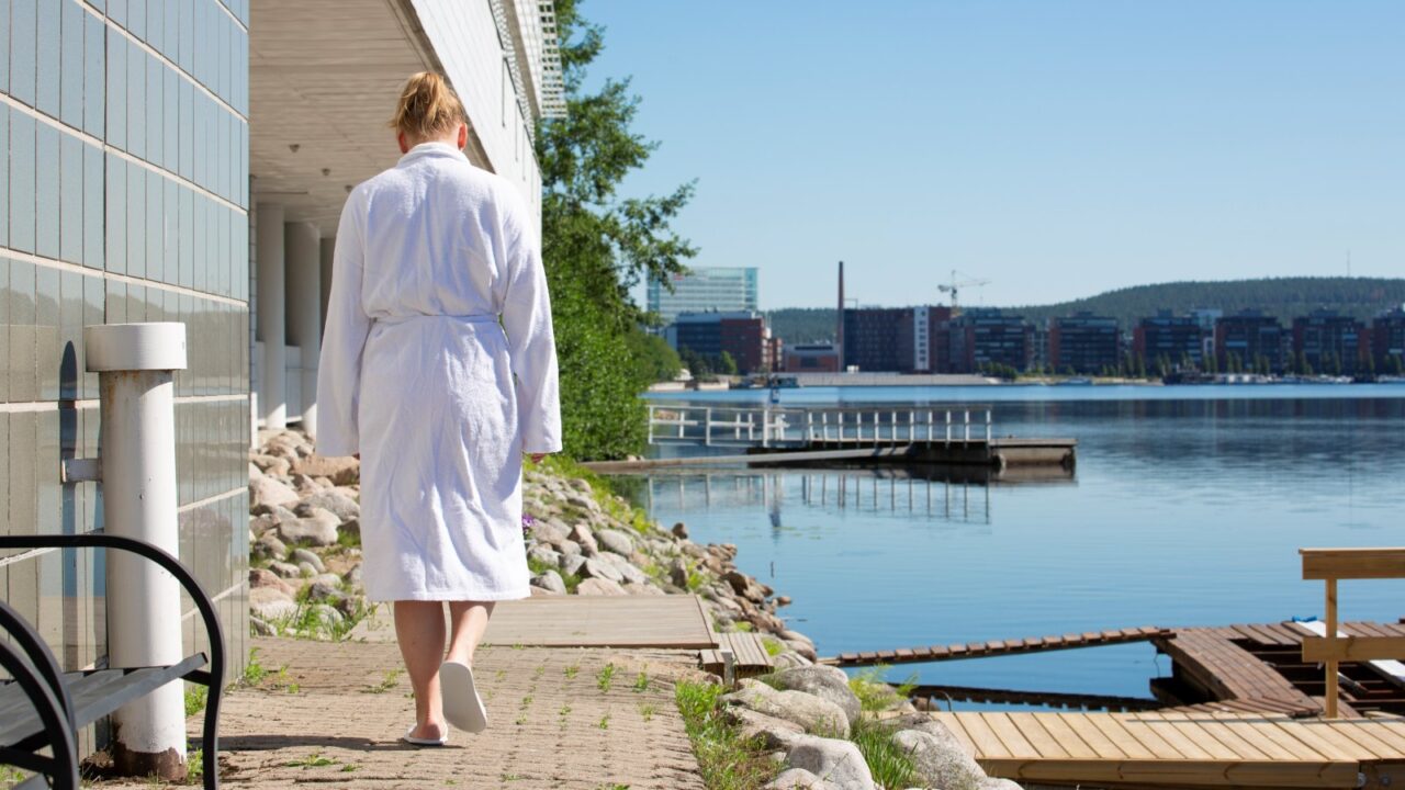 Henkilö kävelee Hotelli Alban edessä kylpytakki päällä.
