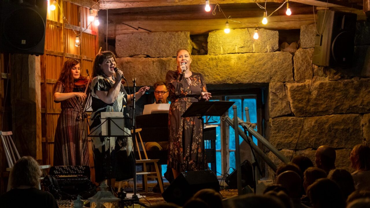The band is playing in an atmospheric old barn.