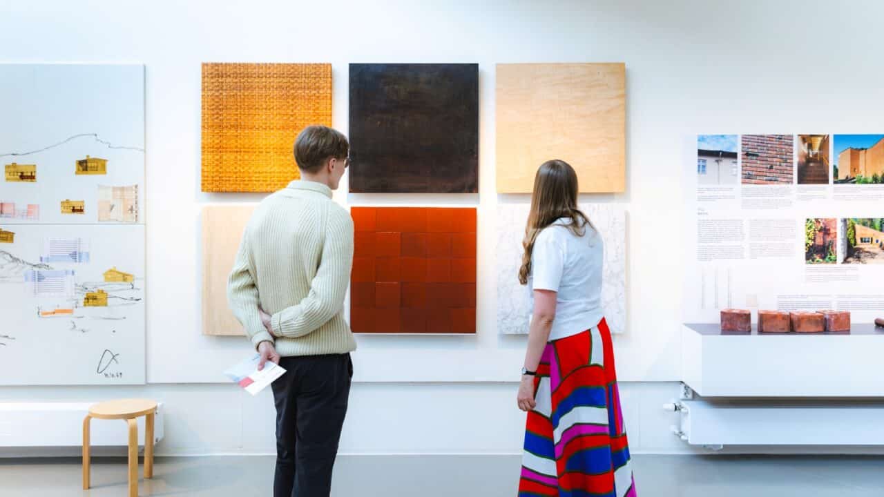Two people at the Aalto2 Museum Centre exhibition.