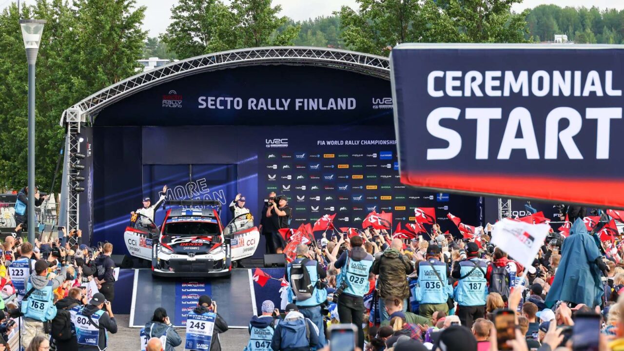 Two Rally drivers next to their car on stage of Secto Rally Ceremonial start.