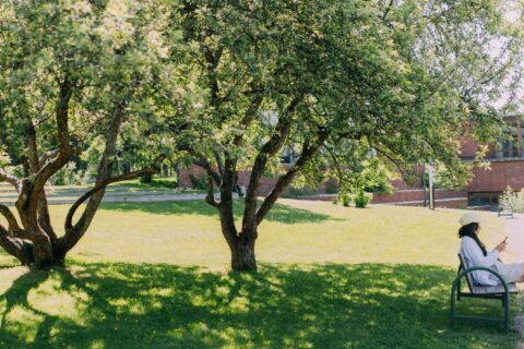 A person is sitting on a bench on Seminaarinmäki campus.