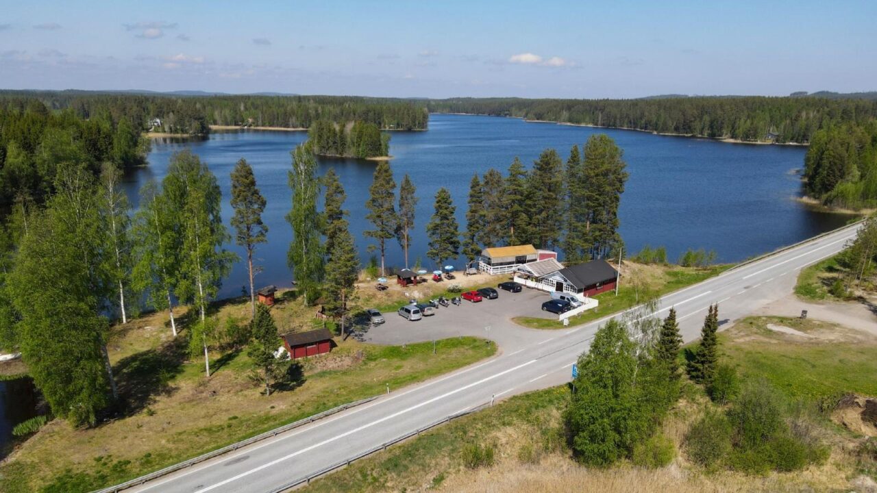Aerial view of the café buildings, with a lake in the background.