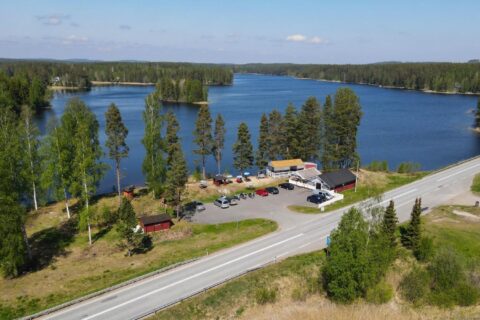 Aerial view of the café buildings, with a lake in the background.